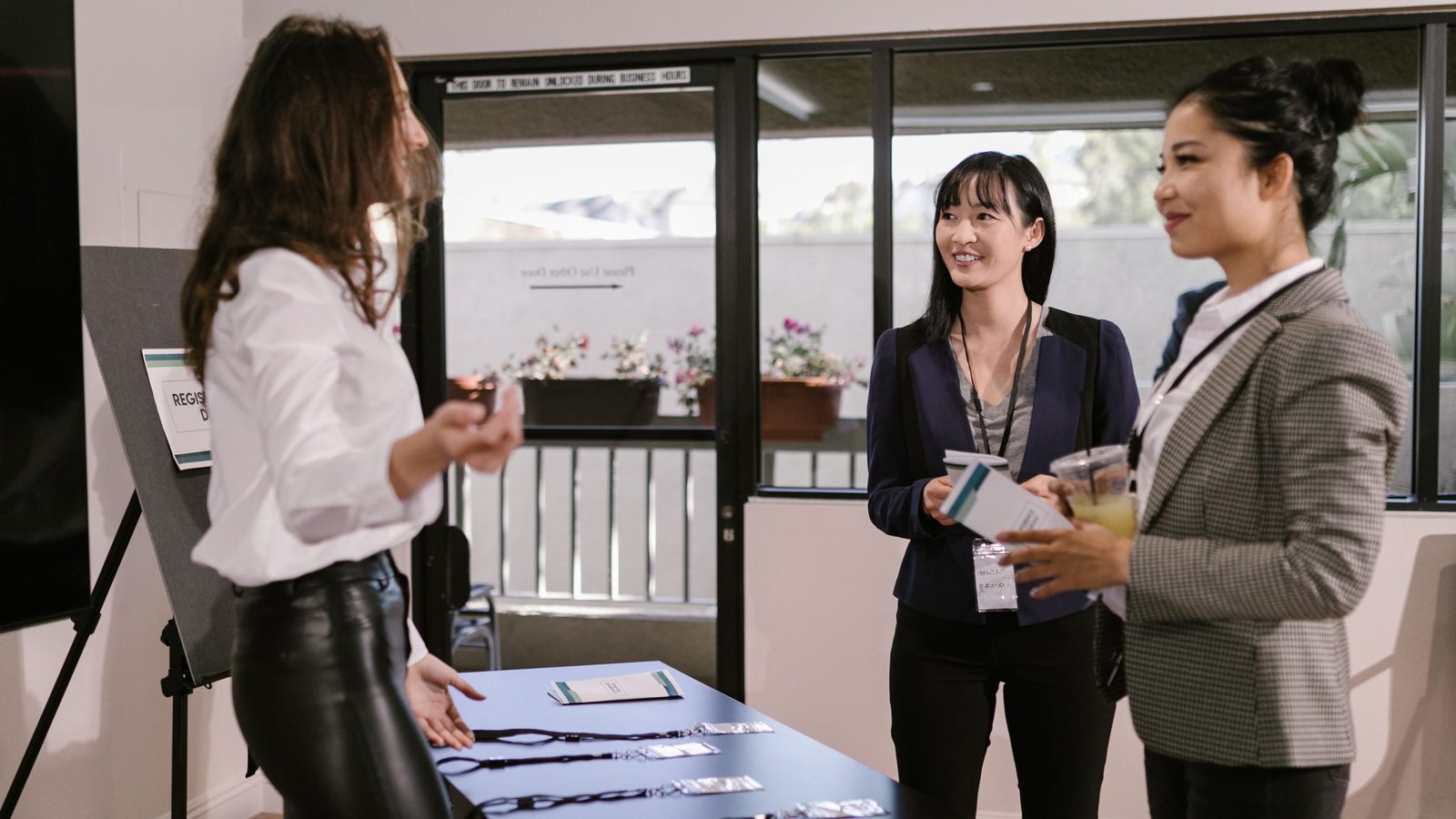 Delegates being welcomed at an event registration desk